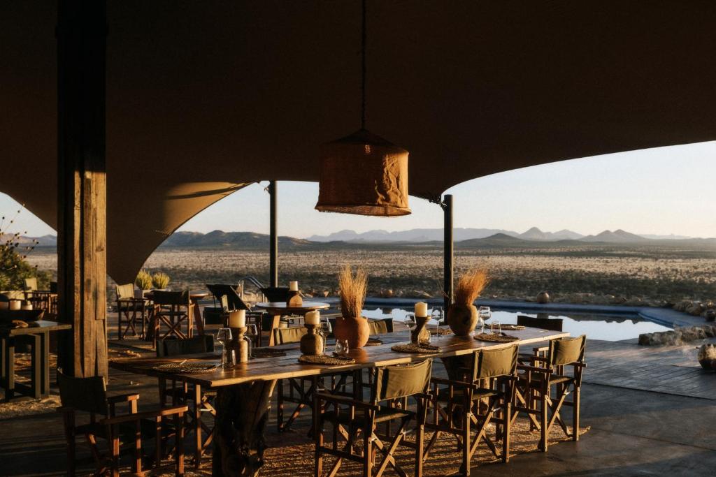 The open-air dining pavilion at Habitas Namibia, set in the savanna of the Namib