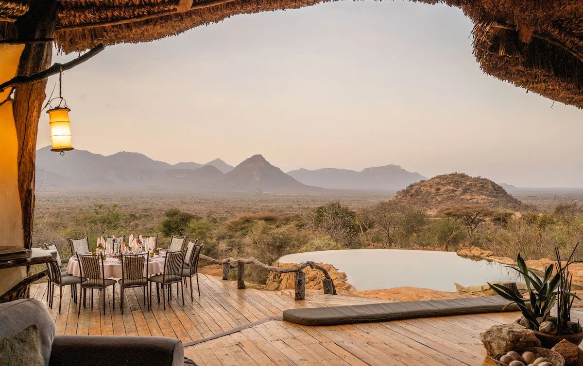 Sarara Camp Kenya thatched dining deck with round table, mountain backdrop, infinity pool, Mathews Range